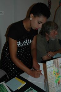 poet Kelsey Harris signs her chapbook