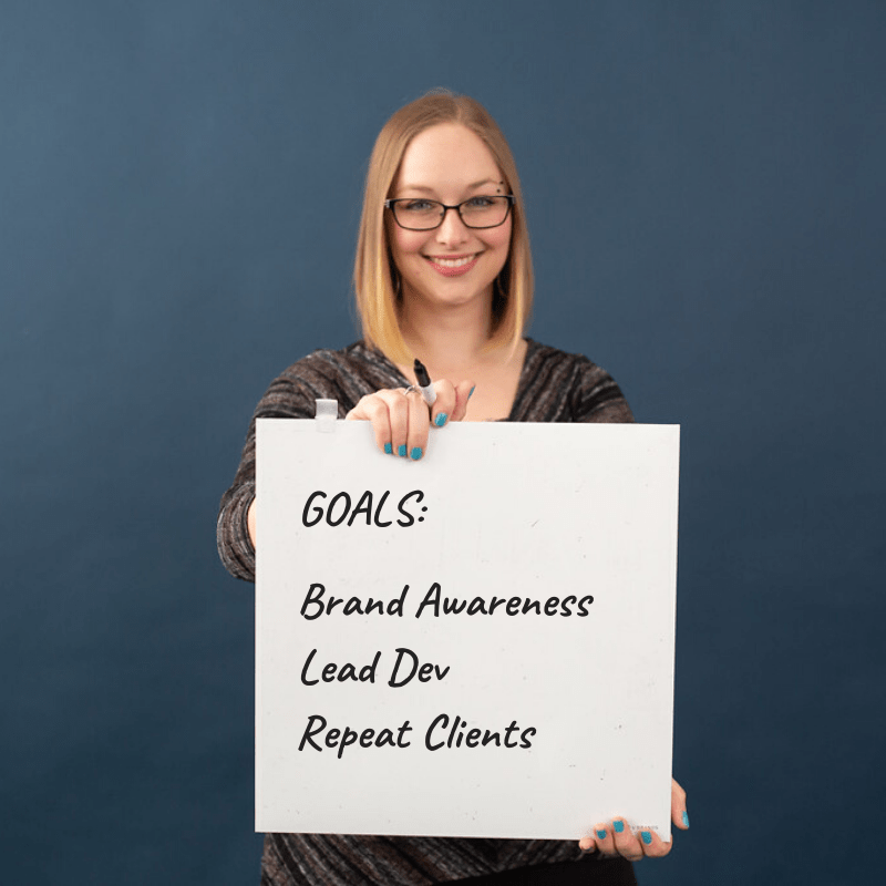 Whiteboard with goals: Brand awareness, lead development, repeat clients